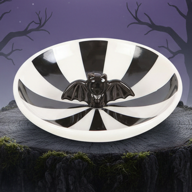 Black and white striped dish with a bat design on a white background