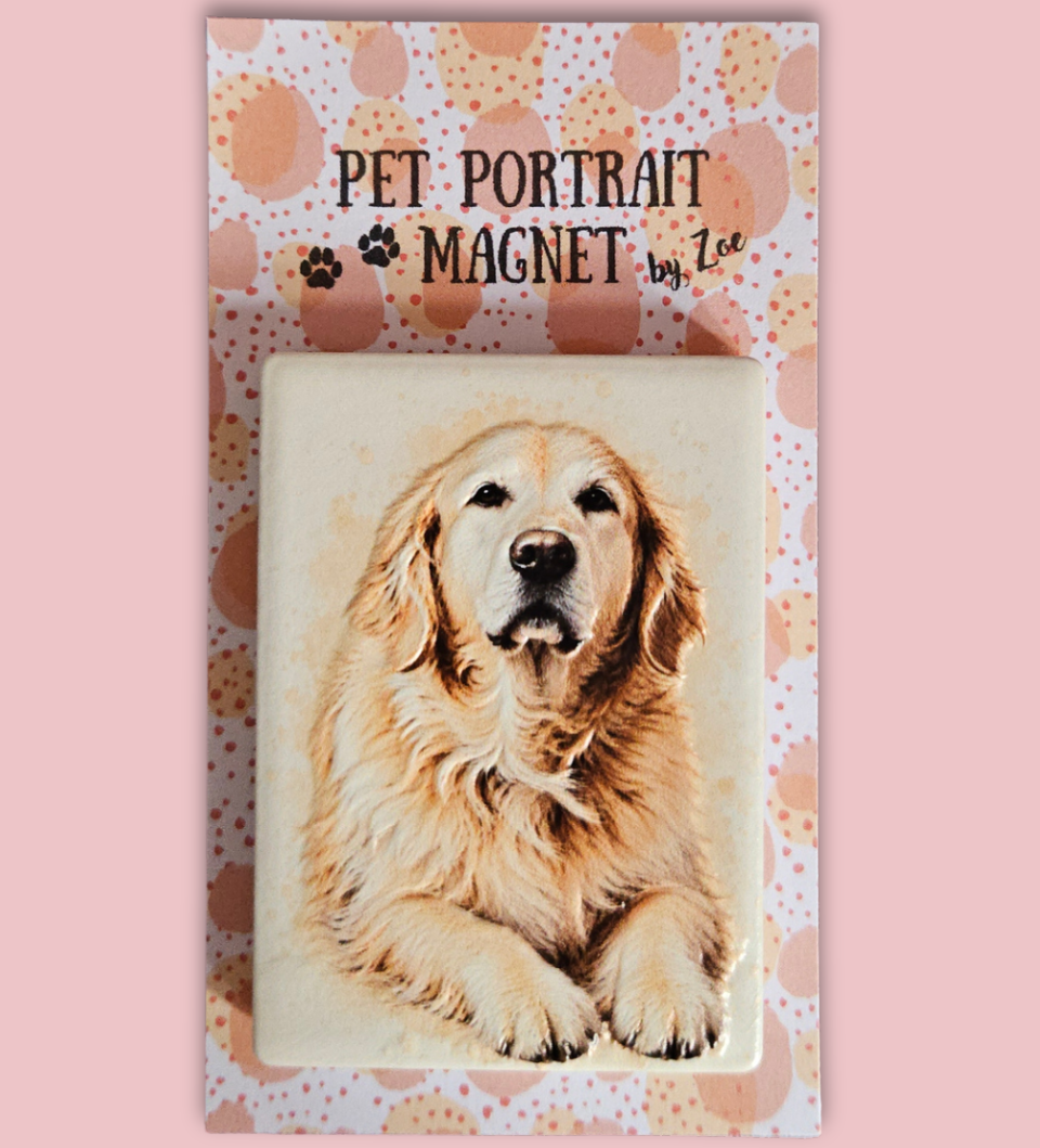 A rectangular pet portrait magnet featuring a painted golden retriever, displayed on a decorative backing card that reads 'PET PORTRAIT MAGNET by Zoe' against a solid pink background.