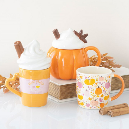 Set of ceramic mugs with autumn-themed designs on a white background