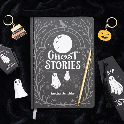 Notebook titled 'Ghost Stories' with ghost-themed accessories on a dark background
